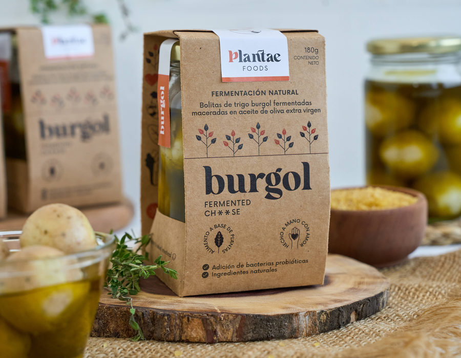 Packaging de Burgol Fermented Cheese junto al frasco en aceite de oliva